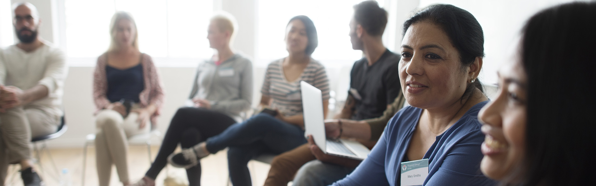 Group of people sat in a semi circle at a training event