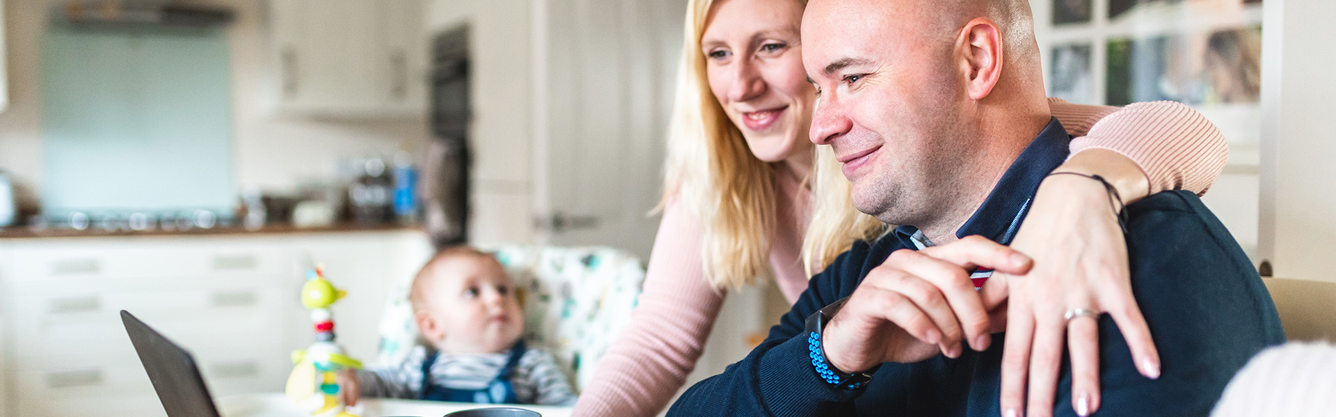 Couple working from home with baby nearby - homepage