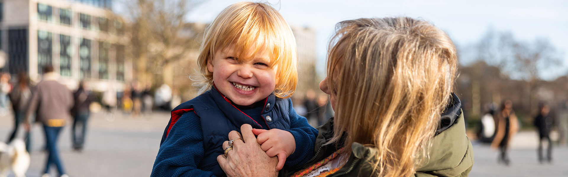 Grandmother and grandson laughing together banner