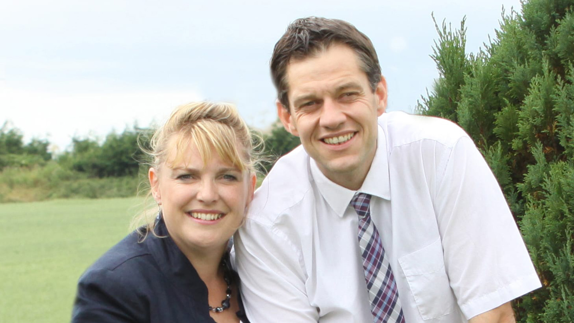 Lincolnshire Fostering Service foster carers, Jacqueline P. and her husband Matthew B, pose smiling looking at the camera.
